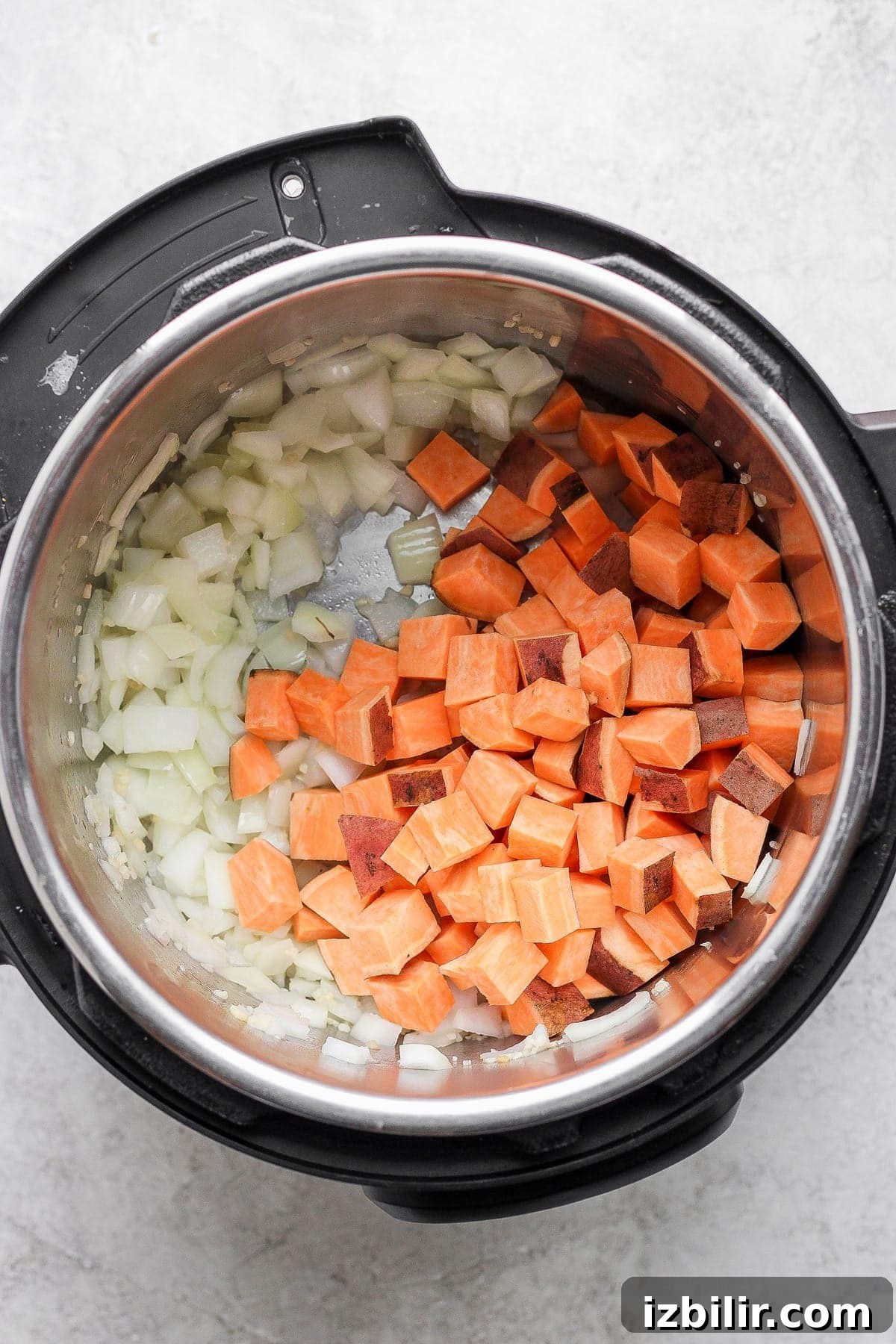 Quick Instant Pot Lentil Soup Recipe for Weeknights 3 Sweet potatoes and onion in an Instant Pot.