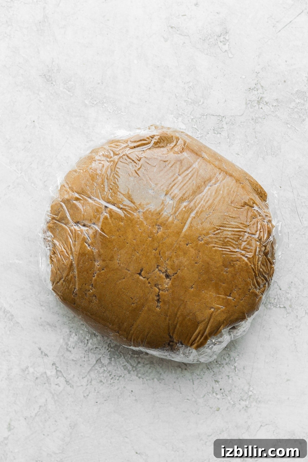 Gingerbread cookie dough wrapped in plastic wrap.
