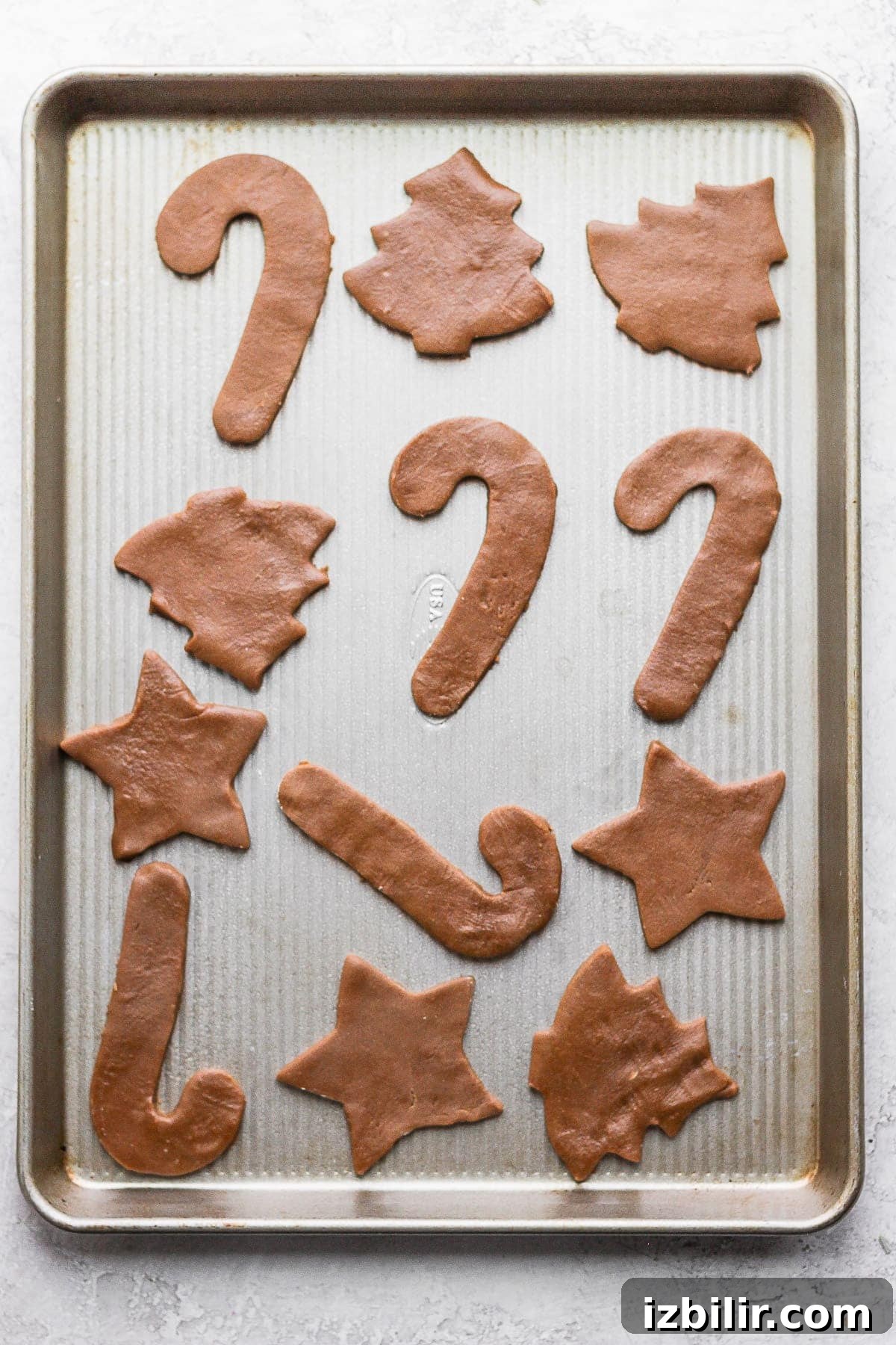 Raw gingerbread cookie dough on a baking sheet
