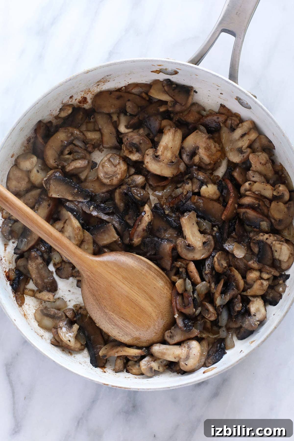 Sautéd mushrooms in a fry pan.