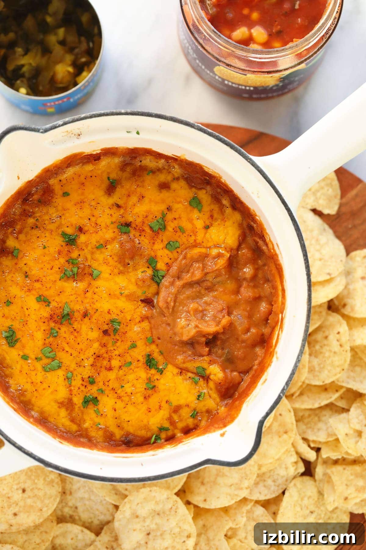 bean dip covered in melted cheese in a skillet