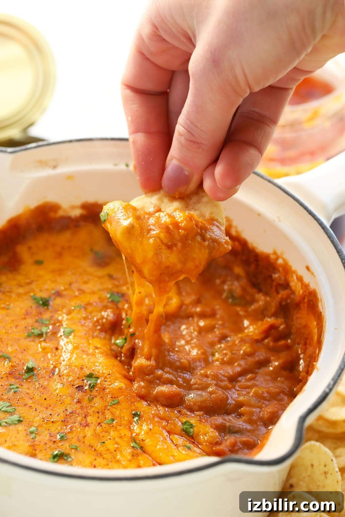 bean dip on a tortilla chip with melted cheese