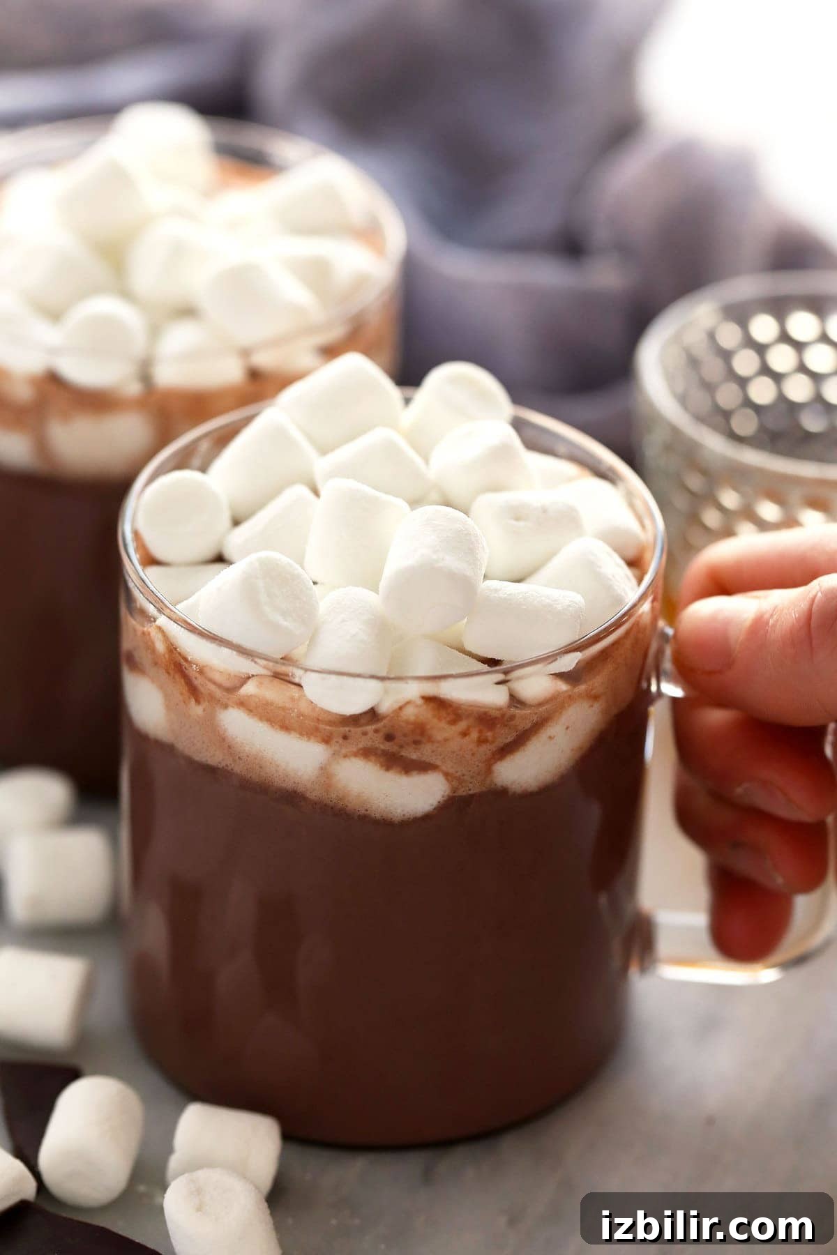 Mug of spiked hot chocolate topped with mini marshmallows ready to serve