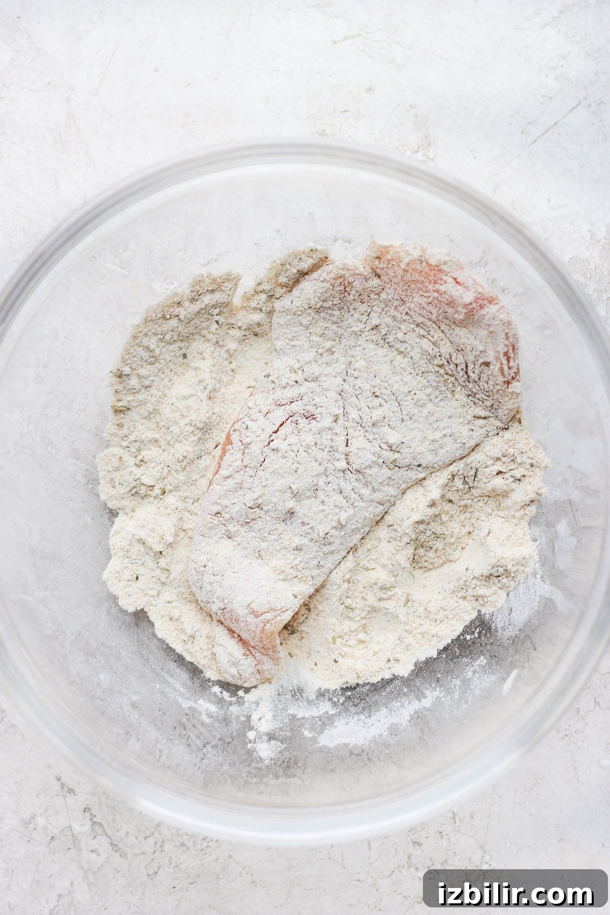 Chicken dredged in flour.