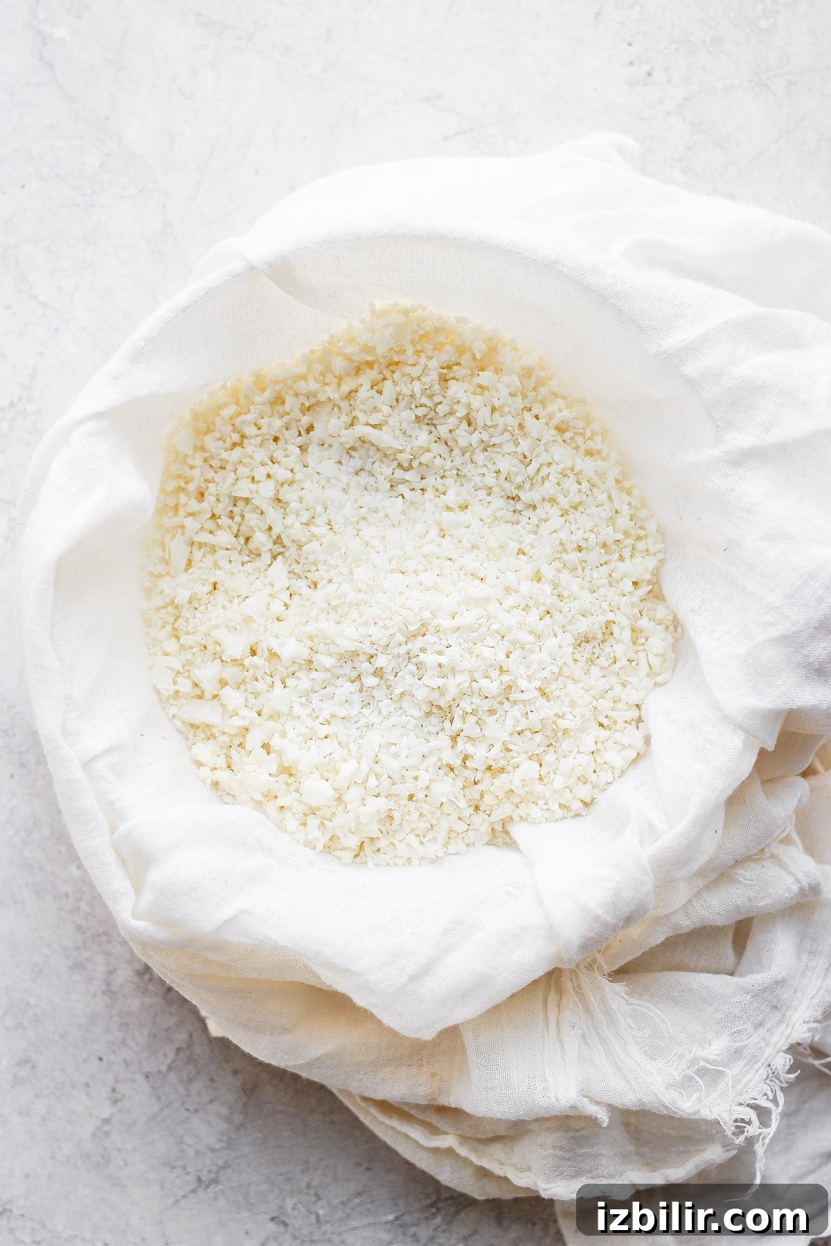 Gluten-Free Cauliflower Pizza Crust Recipe 4 Cauliflower rice in a tea towel.
