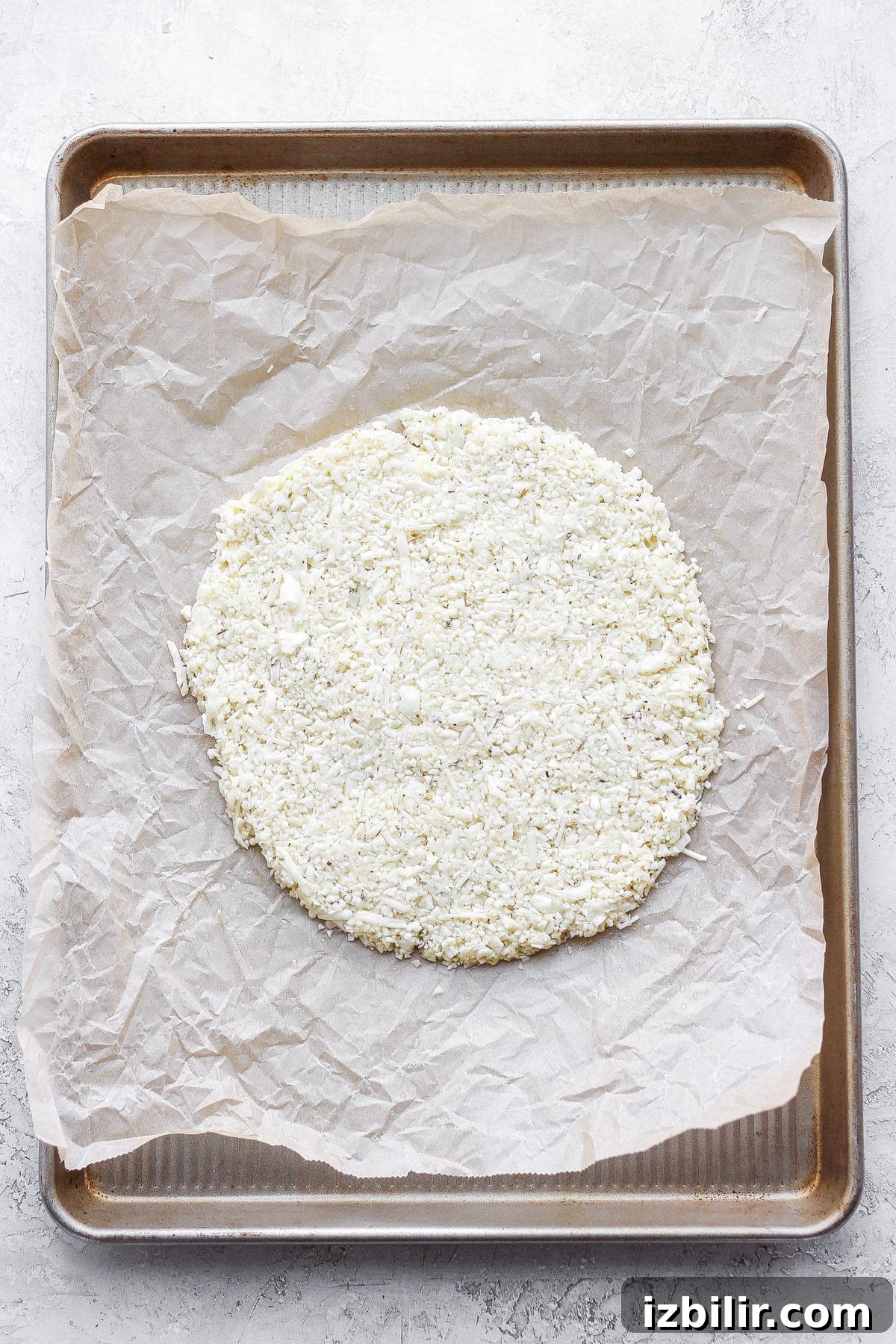 Gluten-Free Cauliflower Pizza Crust Recipe 7 Cauliflower pizza crust made into a circle on a baking sheet.