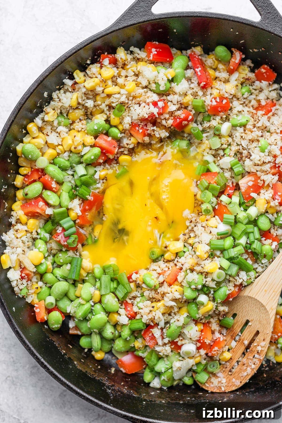 Finished cauliflower fried rice in skillet cauliflower fried rice with eggs scrambled in the middle of the skillet