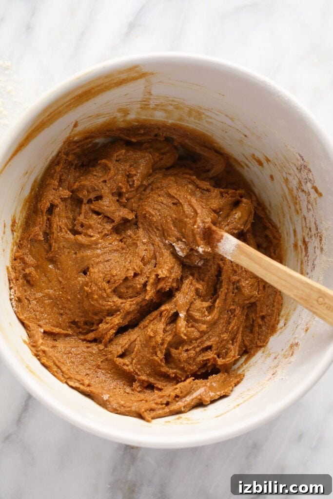Gingerbread cookie bar batter mixed together in a bowl