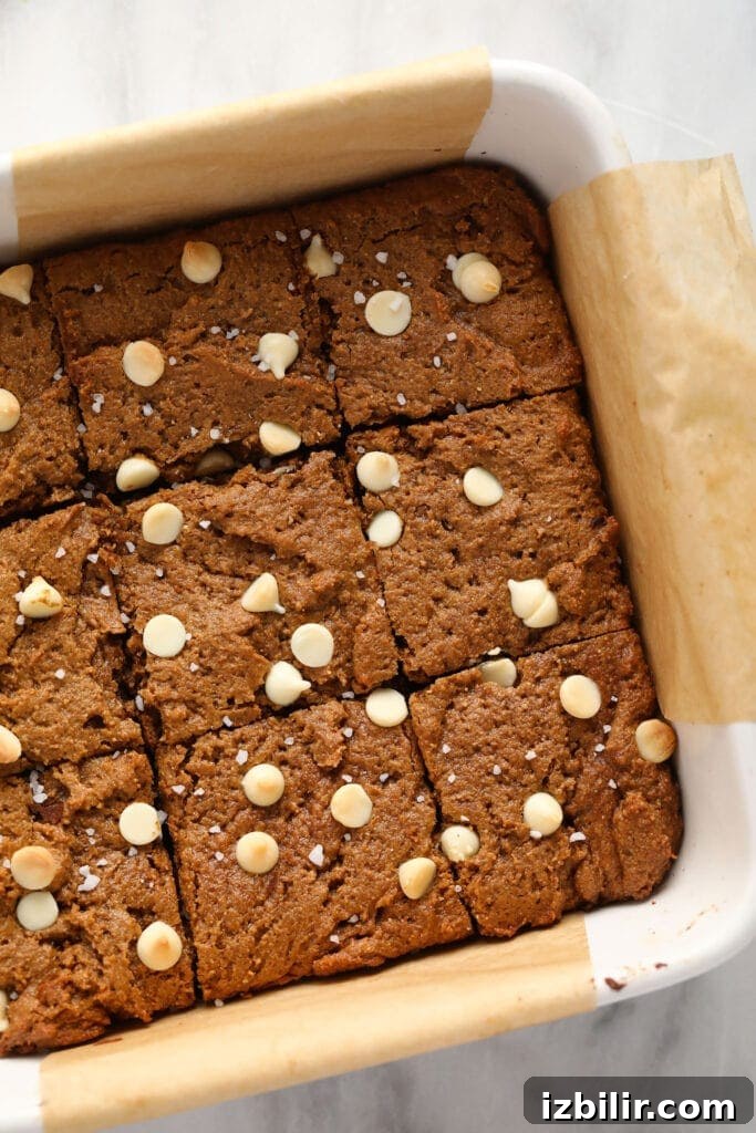Gingerbread cookie bars in a baking dish cut into square bars
