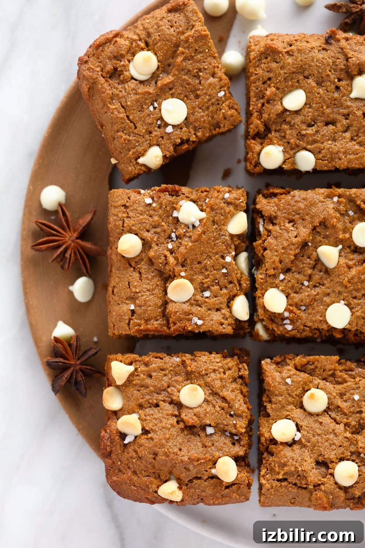 Gingerbread cookie bars topped with white chocolate chips and sea salt