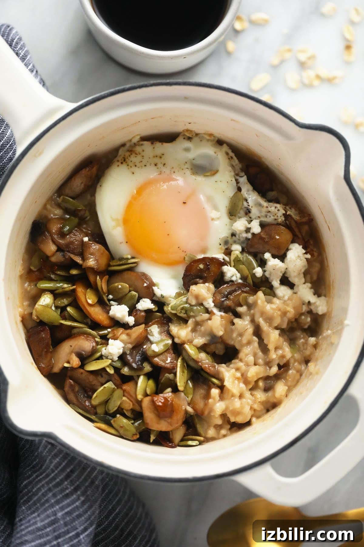 Savory Oatmeal Recipe for a Hearty Breakfast 2 Savory oatmeal in a pot topped with an egg.