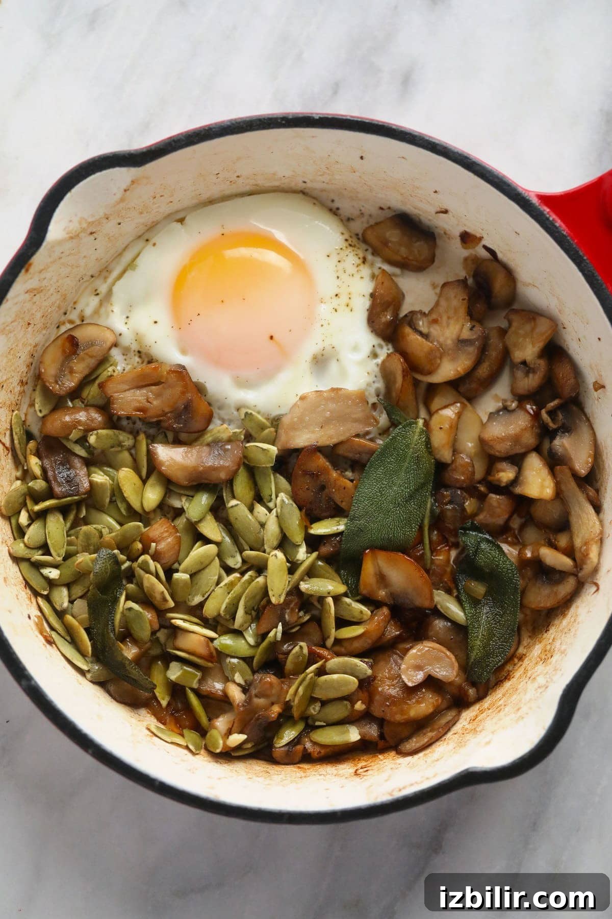 Savory Oatmeal Recipe for a Hearty Breakfast 3 Savory oatmeal in a small pot with savory toppings, including an egg.