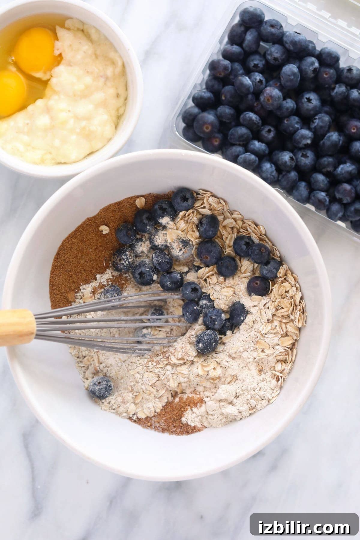blueberry oatmeal muffin ingredients in a bowl