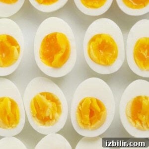 A group of hard boiled eggs on a white surface.