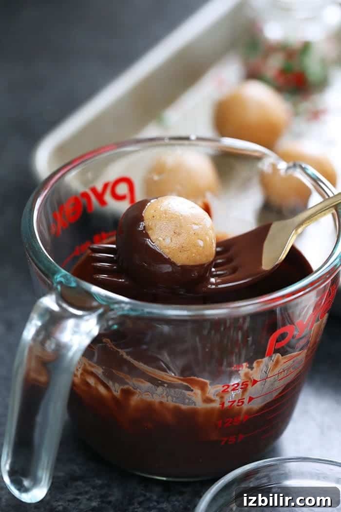 No-Bake Chocolate Peanut Butter Protein Buckeyes Recipe 3 A measuring cup filled with rich, indulgent chocolate.