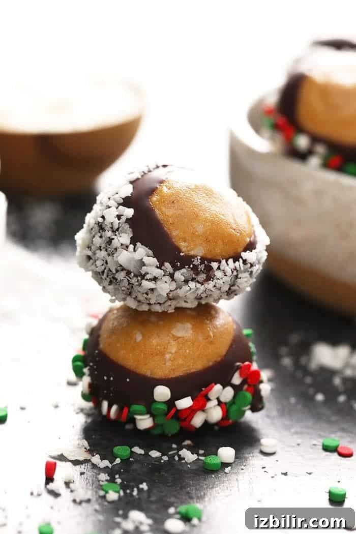 No-Bake Chocolate Peanut Butter Protein Buckeyes Recipe 5 A stack of healthy chocolate covered peanuts with sprinkles on top.