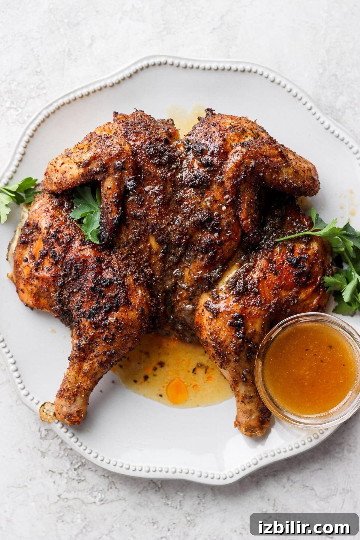 Spatchcock chicken on a platter.