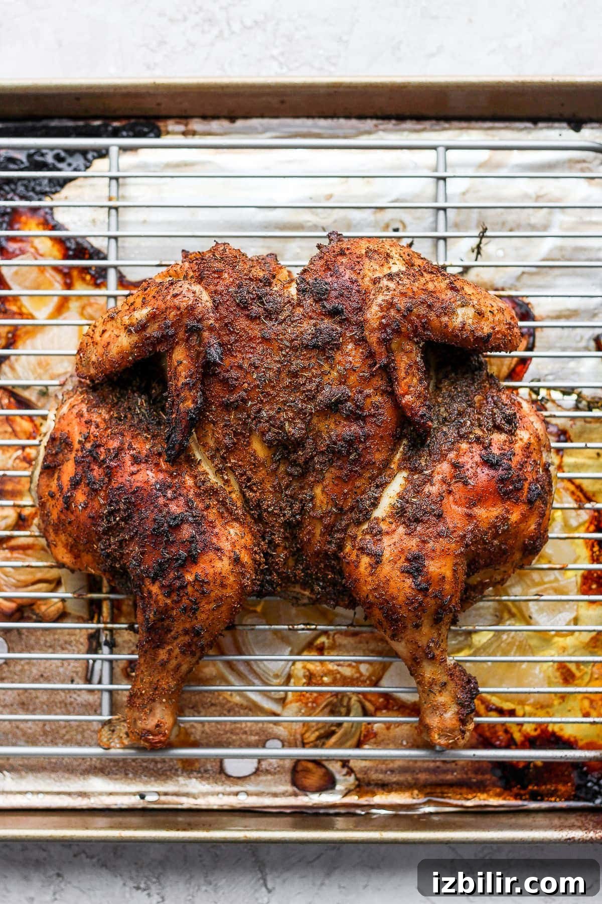 Spatchcock chicken on a making sheet.