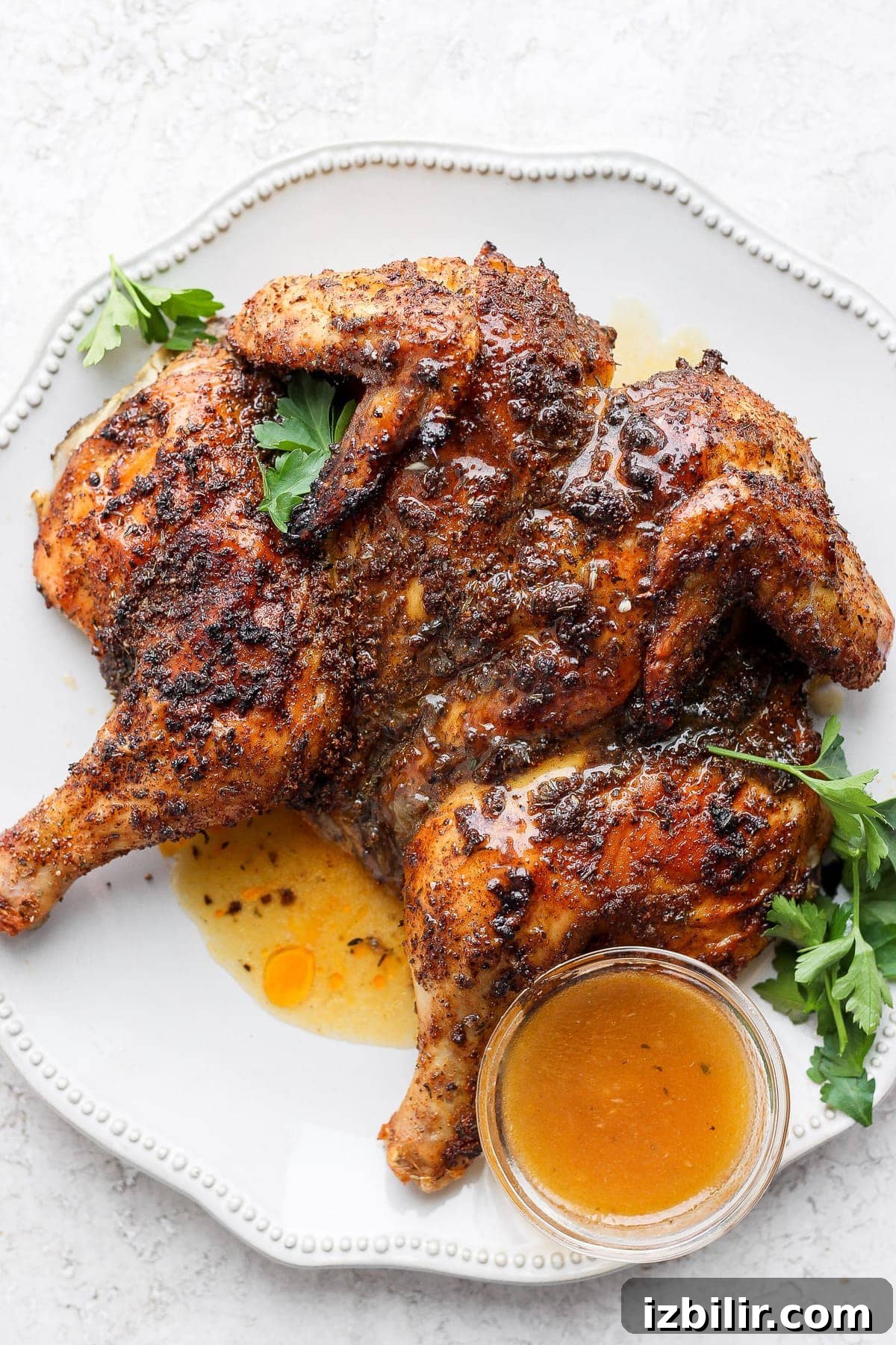 Spatchcock chicken on a platter.