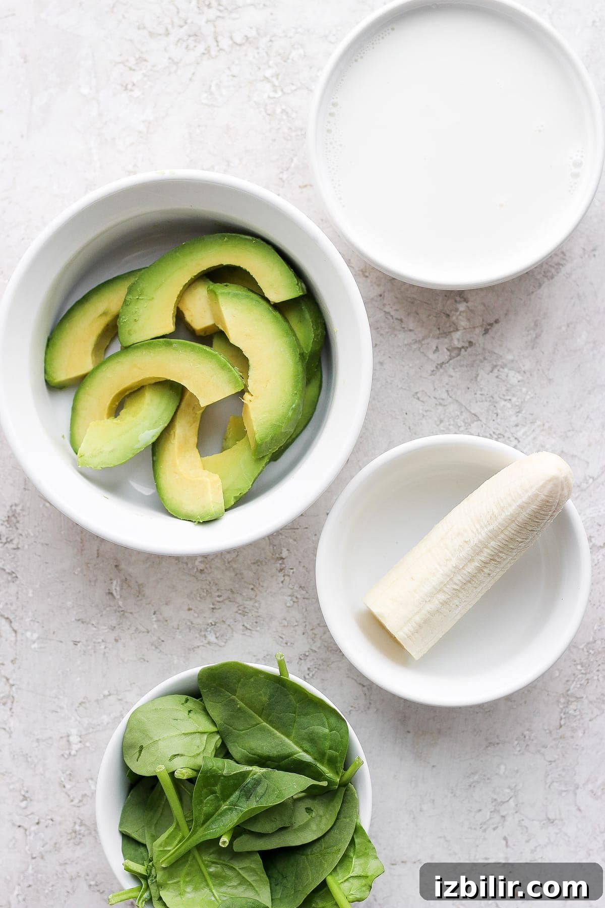 avocado smoothie ingredients in bowls, ready to be added to a blender