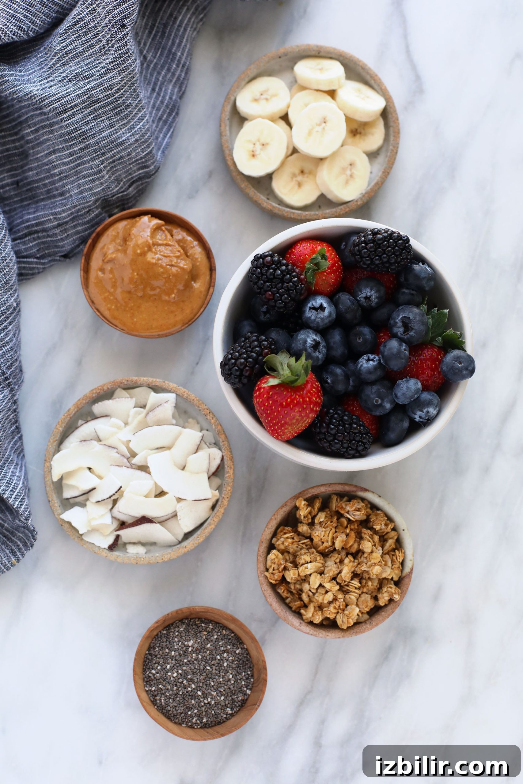 berries, peanut butter, coconut, granola, chia seeds, and banana slices