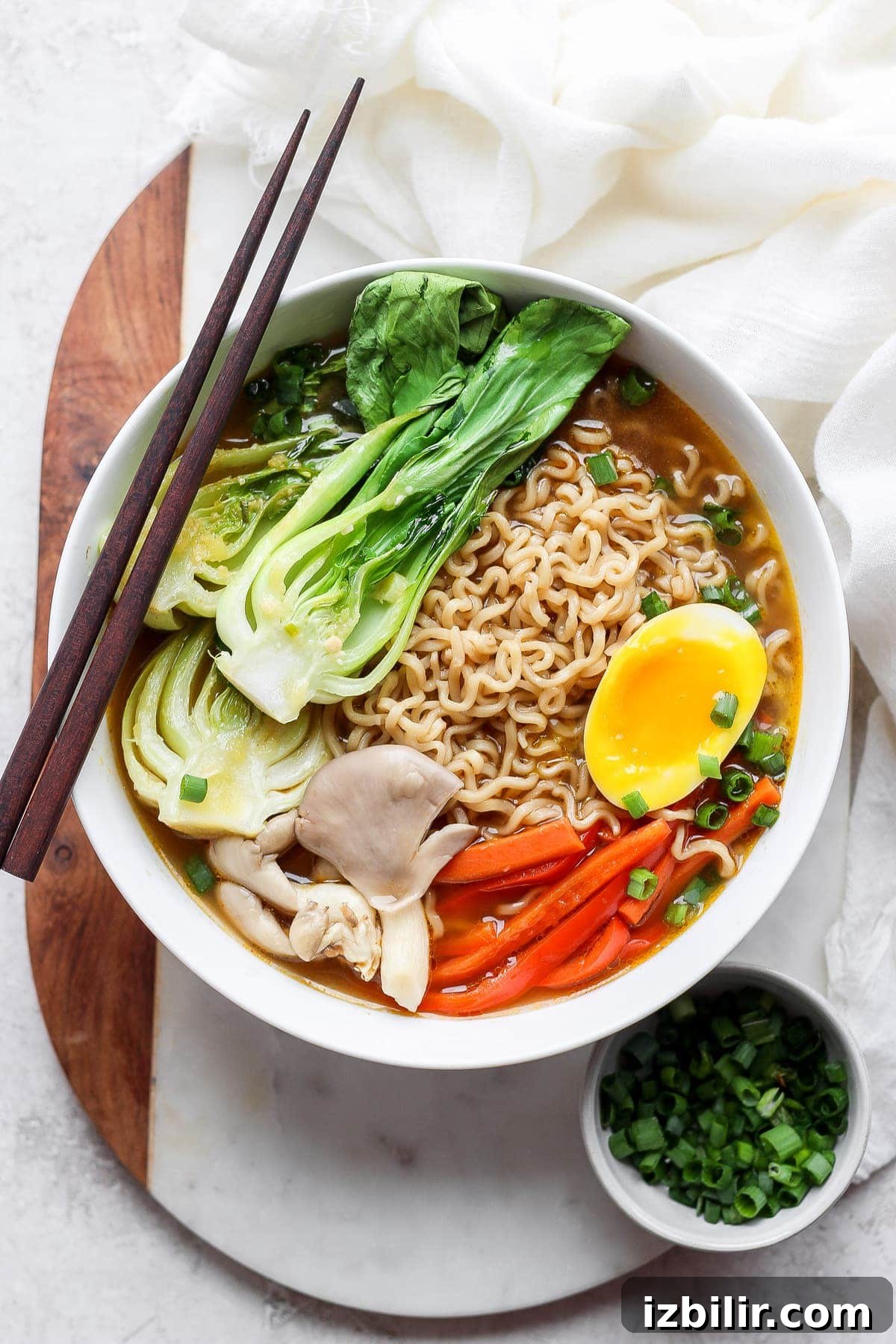 Ramen in a bowl with a soft boiled egg.