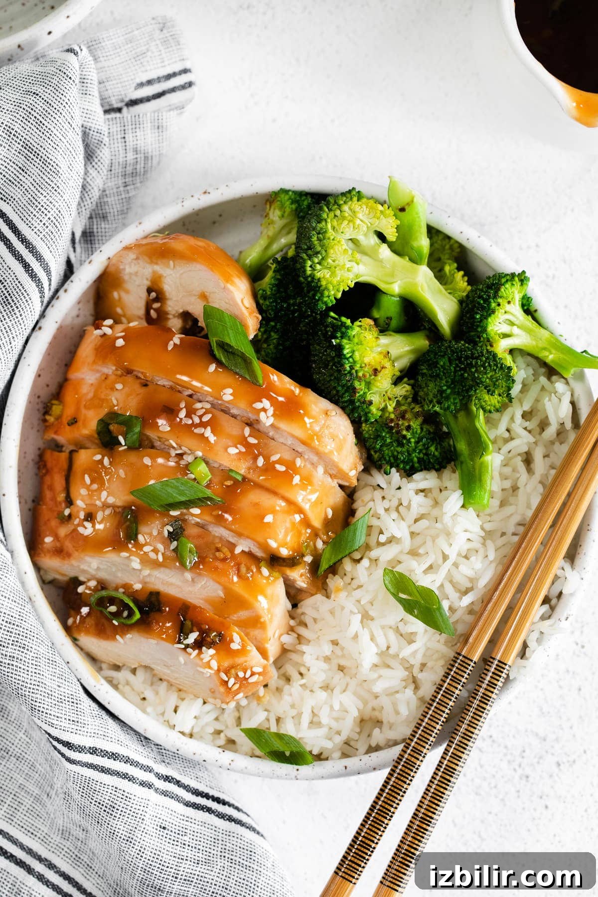 Seriously delicious baked teriyaki chicken breast comes together with easy-to-find ingredients. This teriyaki chicken comes out so tender and saucy! sliced teriyaki chicken next to broccoli and white rice