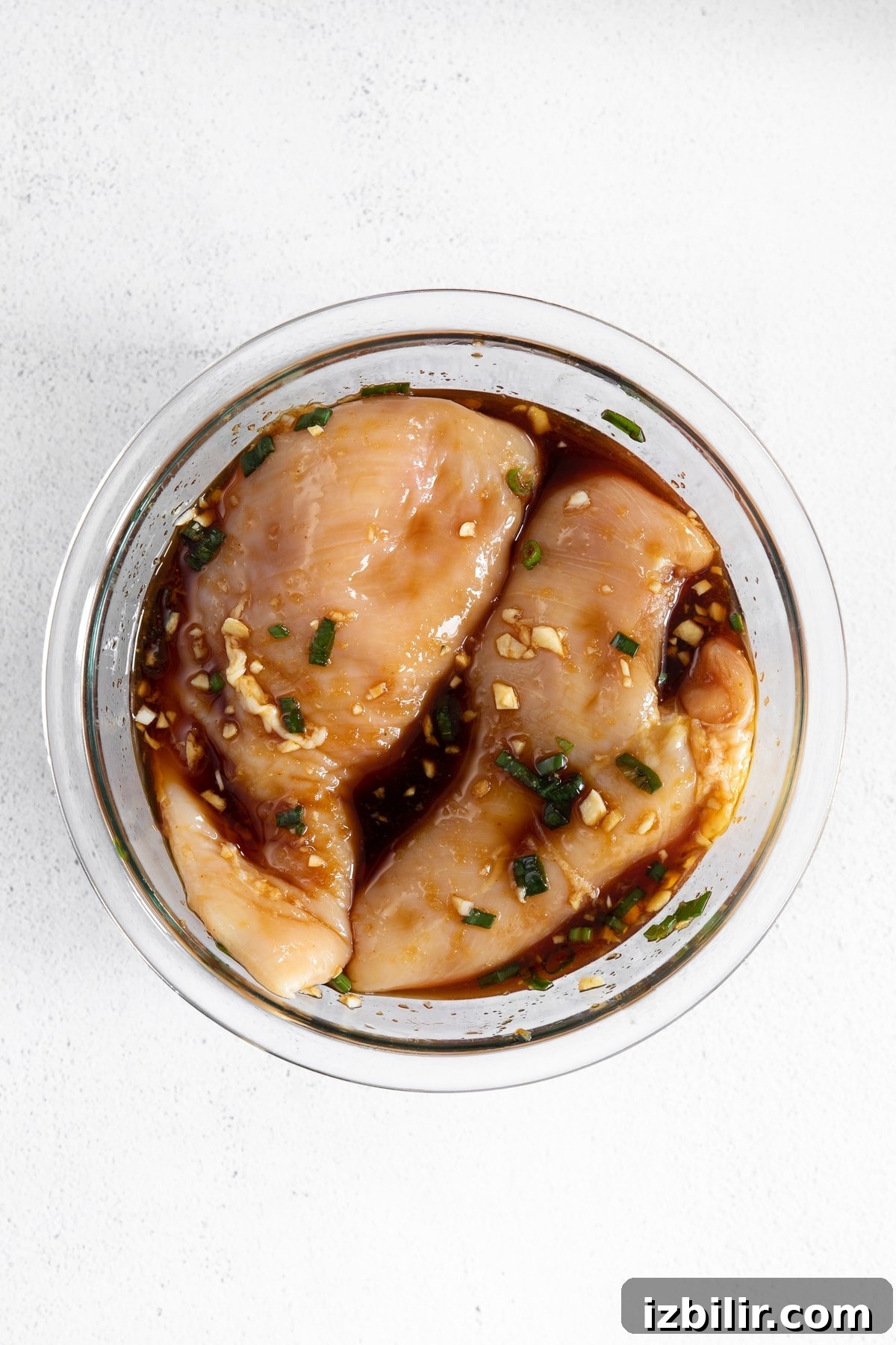 Chicken marinating in teriyaki sauce. teriyaki chicken marinating in glass bowl