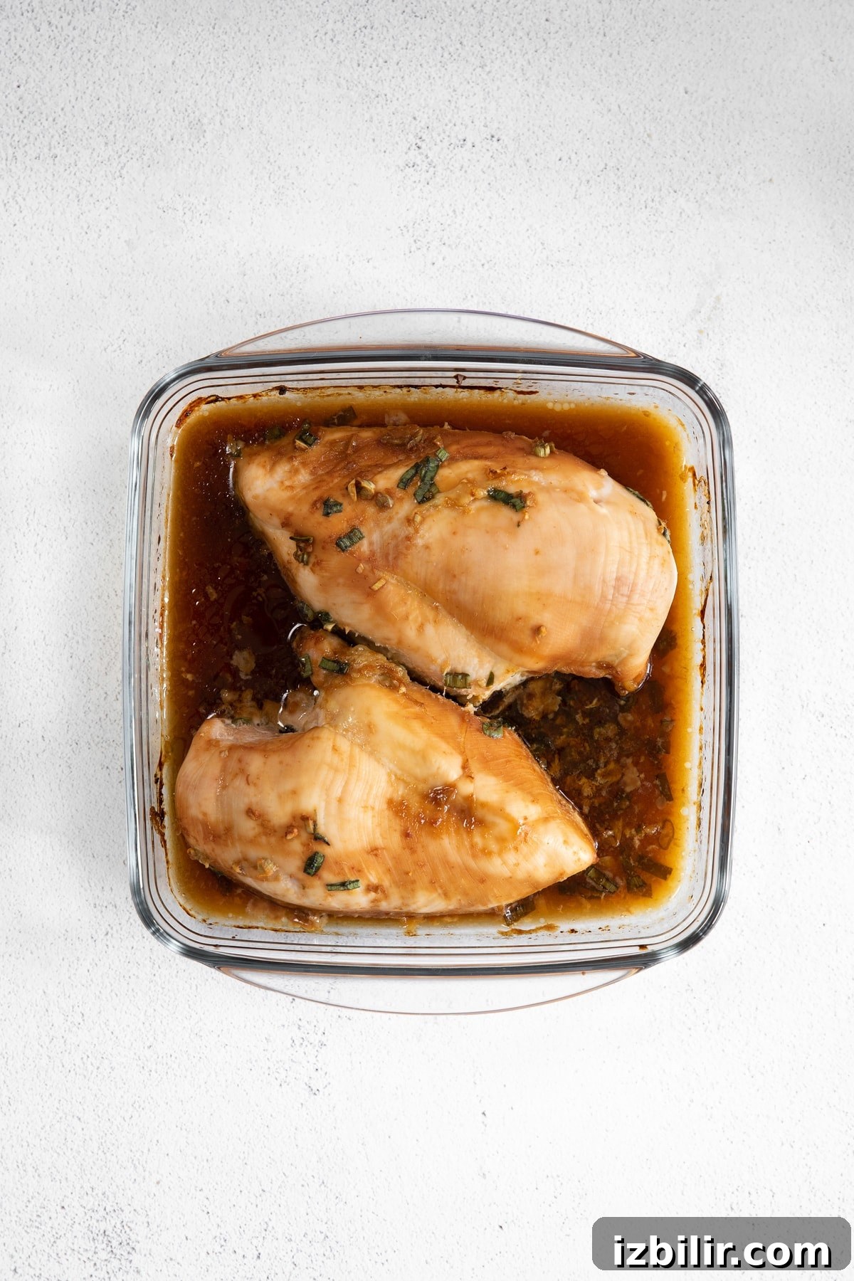 Baked teriyaki chicken in a casserole dish. cooked chicken breast in casserole dish with sauce