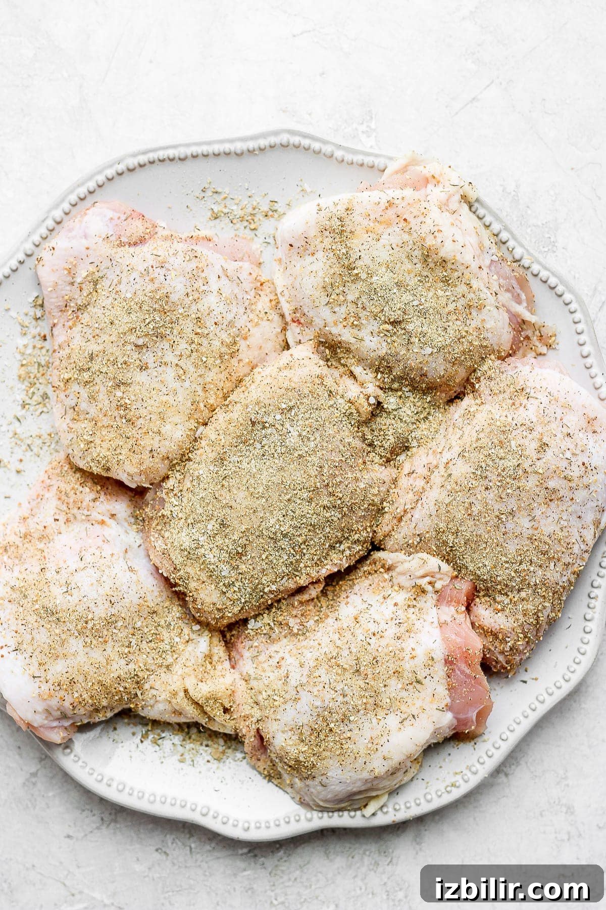 Dutch Oven Chicken Thighs with Crispy Brussels Sprouts 4 seasoned chicken thighs on plate