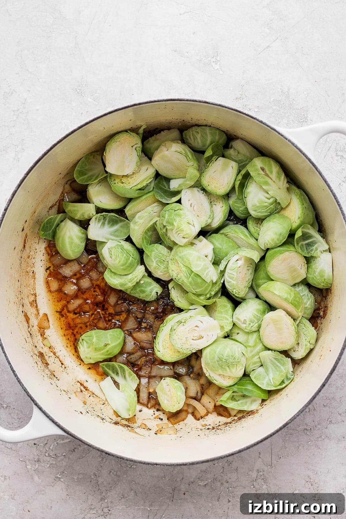 Dutch Oven Chicken Thighs with Crispy Brussels Sprouts 5 uncooked Brussels sprouts and onion in Dutch oven