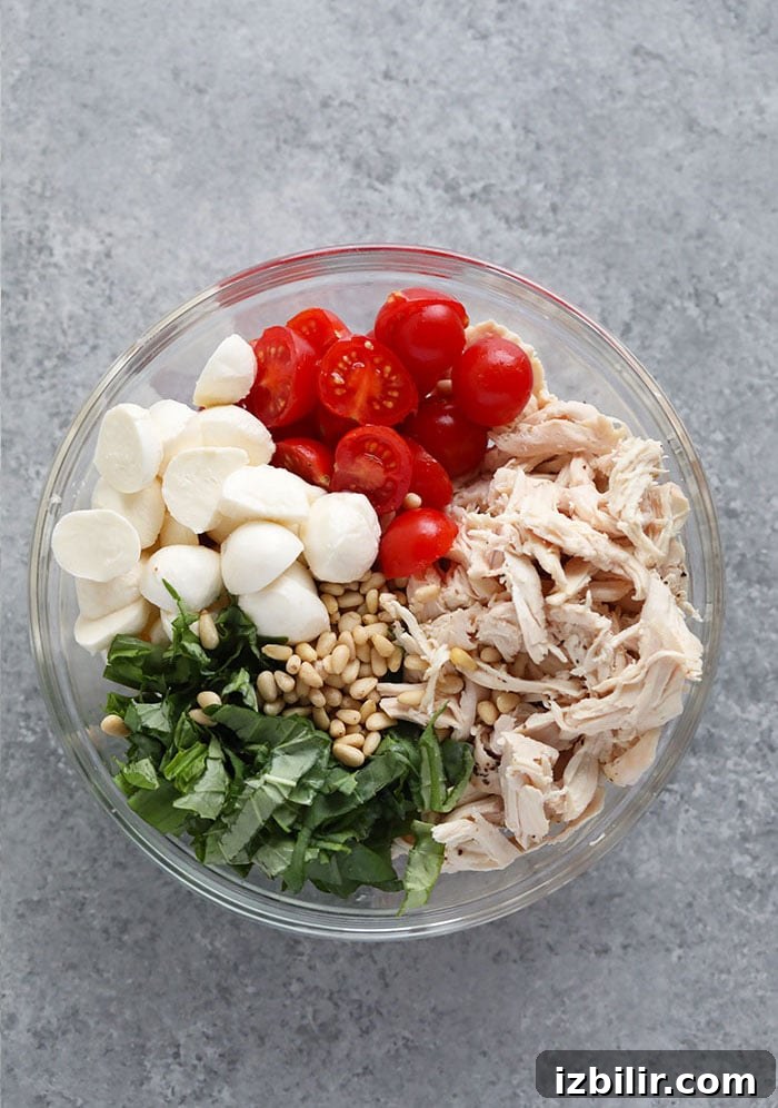 Ingredients for the pesto chicken salad in a bowl.