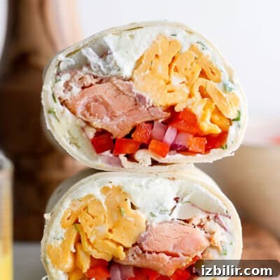 Smoked salmon breakfast burrito with eggs and veggies.