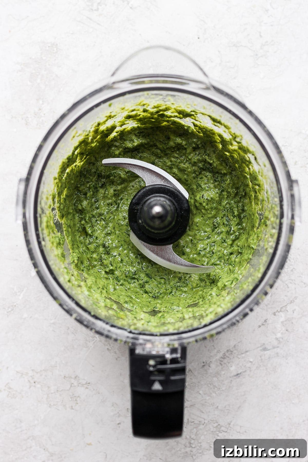 Make this simple vegan pesto recipe with fresh basil, olive oil, lemon juice, and a homemade vegan parmesan cheese. pesto in food processor