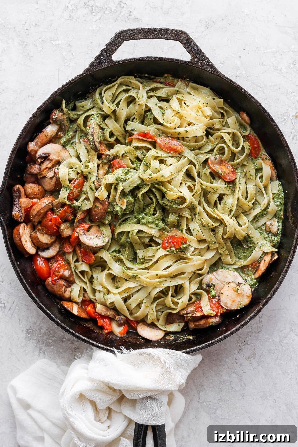 Vegan pesto pasta in a cast iron skillet.