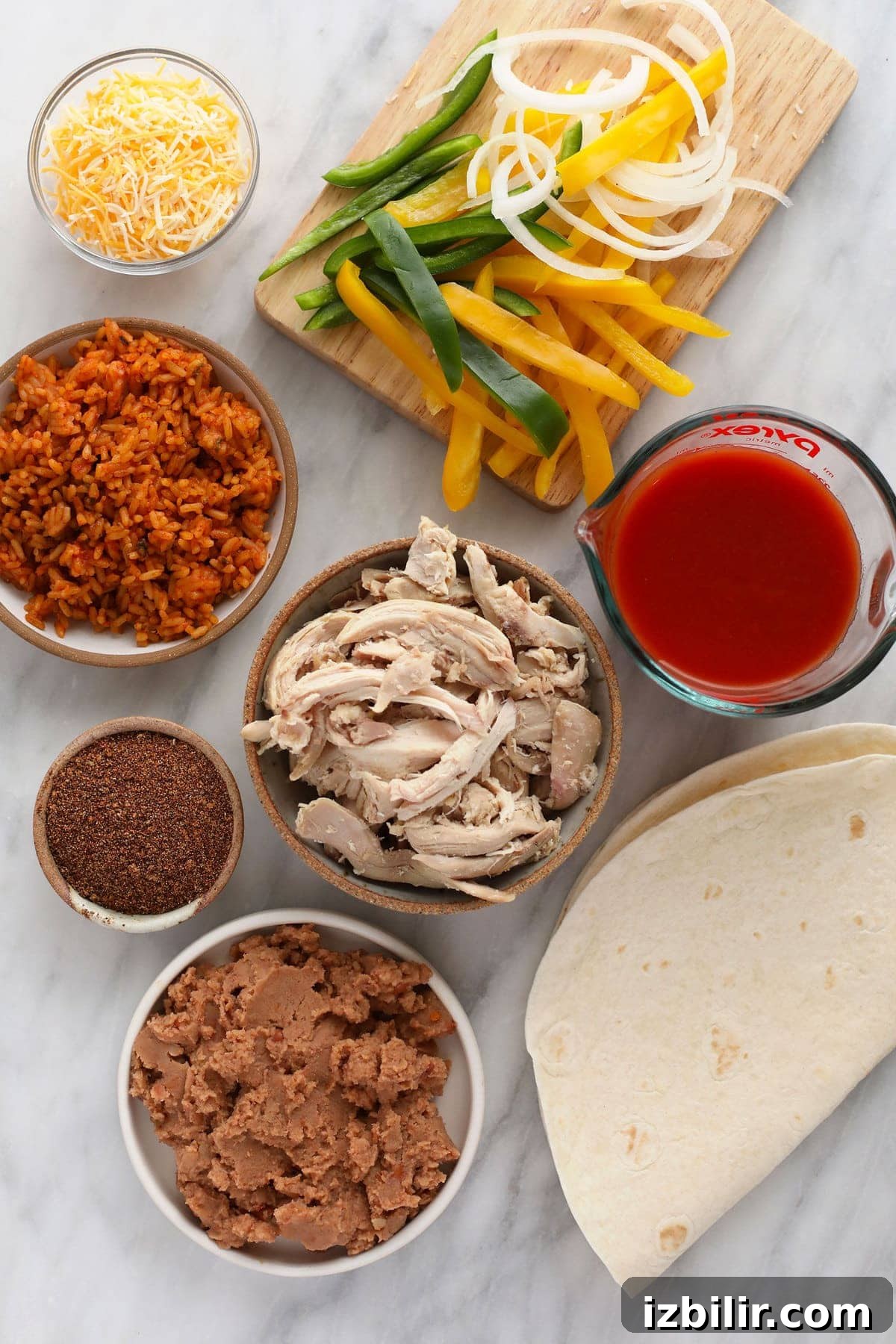 Ingredients for shredded chicken burritos ready to be assembled.