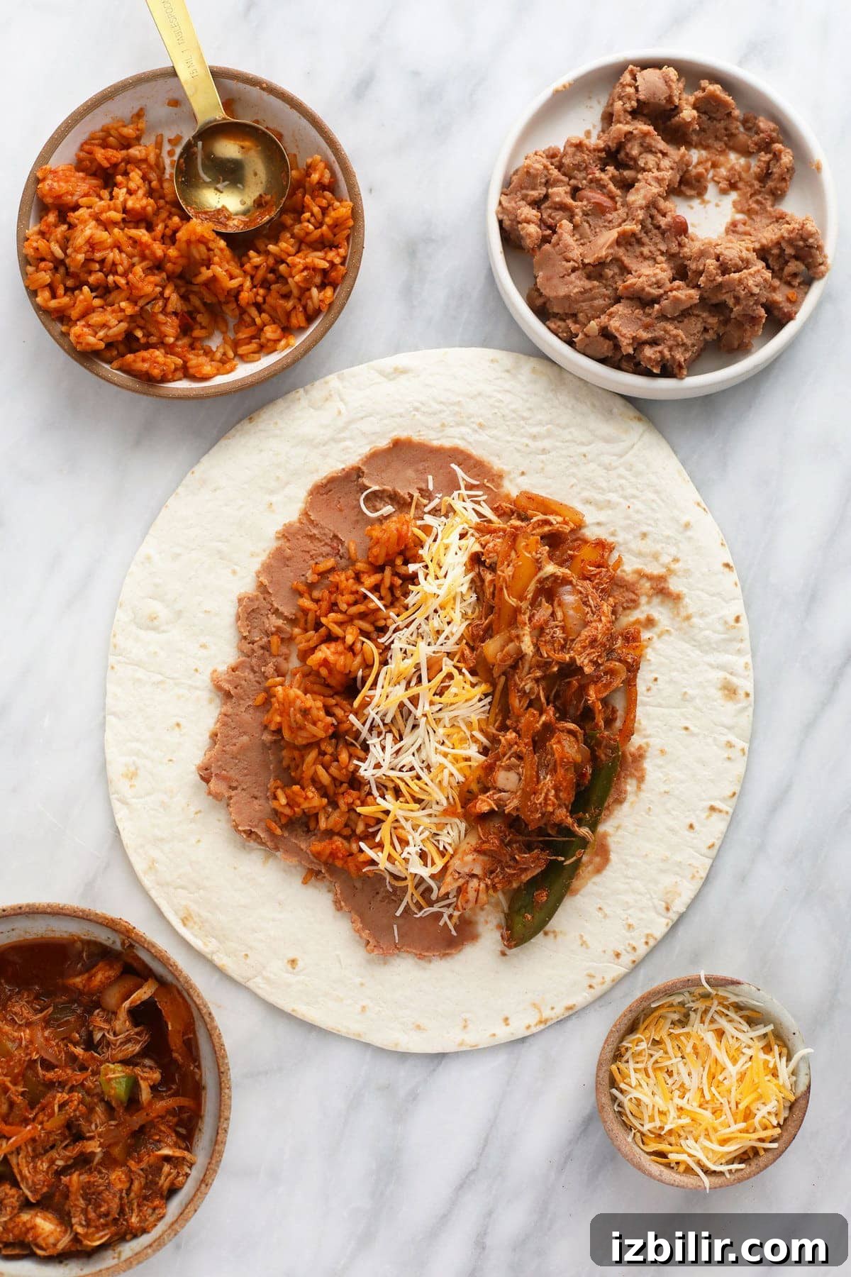 Burrito ingredients being assembled on a tortilla.