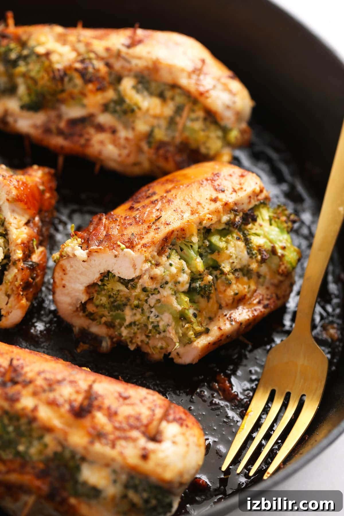 Broccoli and cheese stuffed chicken breast broccoli and cheese stuffed chicken breast in a cast iron skillet.