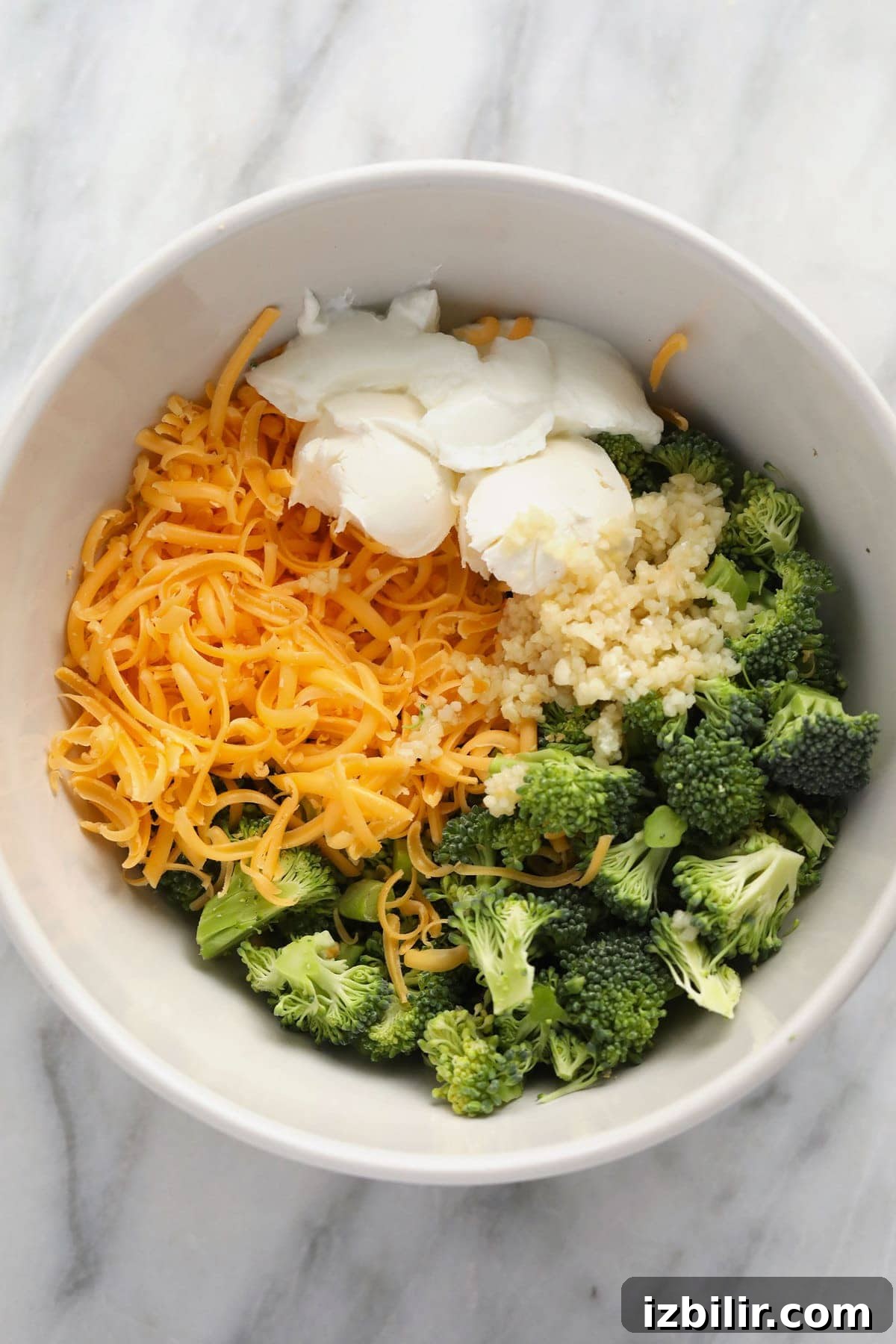 Broccoli and cheese filling mixed in a bowl broccoli and cheese filling in a bowl.