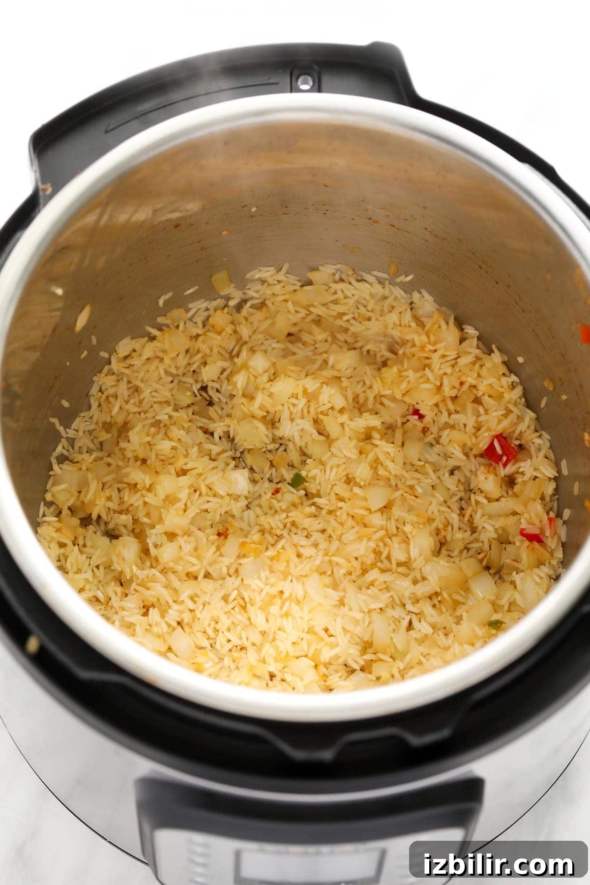 rice and onions in the instant pot for instant pot burrito bowls