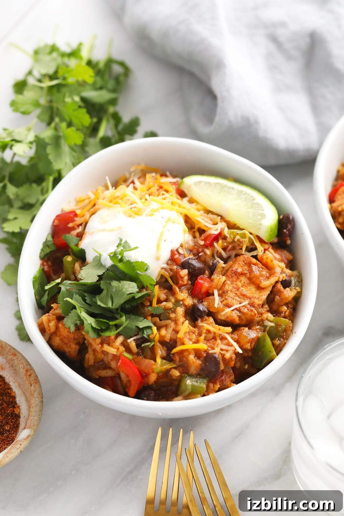 instant pot burrito bowl topped with greek yogurt and shredded cheese