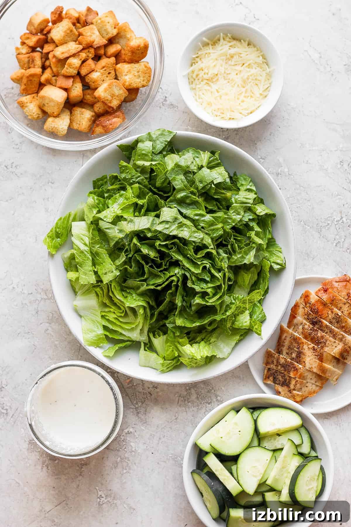 Crispy Chicken Caesar Salad with Homemade Dressing 3 Chicken Caesar salad ingredients in a bowl.