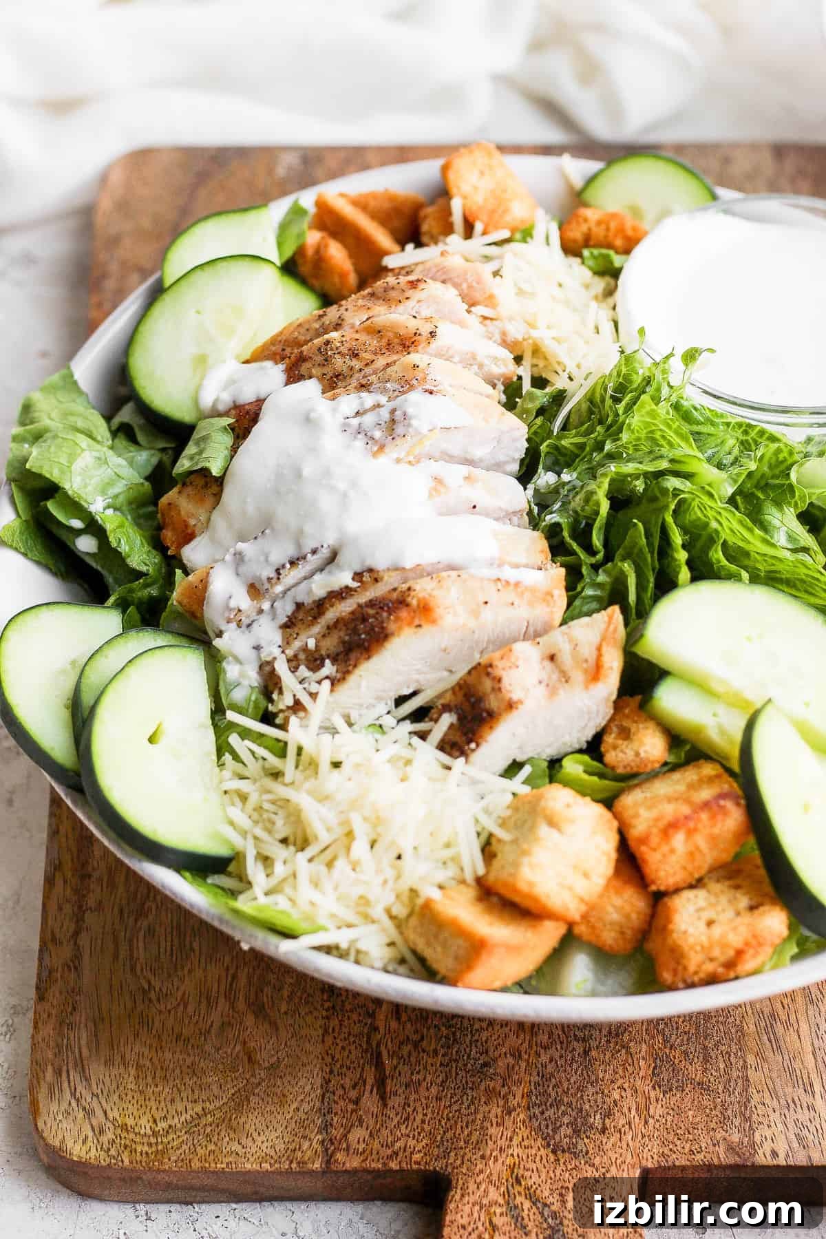 Crispy Chicken Caesar Salad with Homemade Dressing 8 Chicken on top of a salad.
