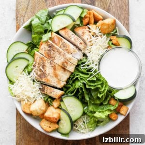 Crispy Chicken Caesar Salad with Homemade Dressing 9 chicken salad with croutons and dressing in a white bowl.