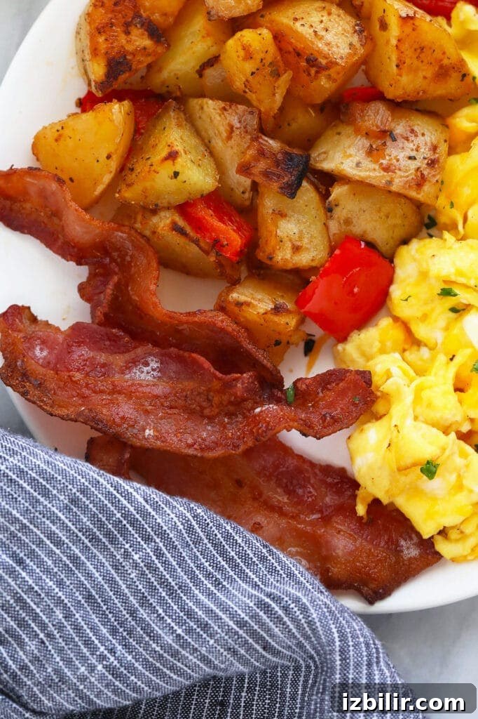 bacon with eggs and potatoes on plate