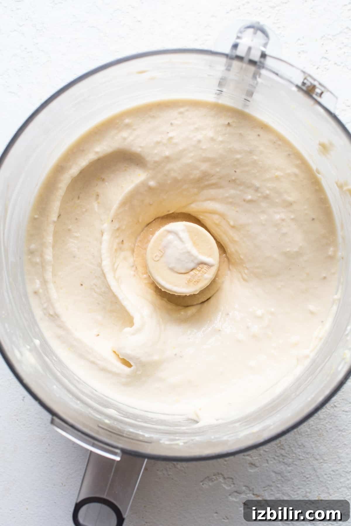A blender with a white substance in it.