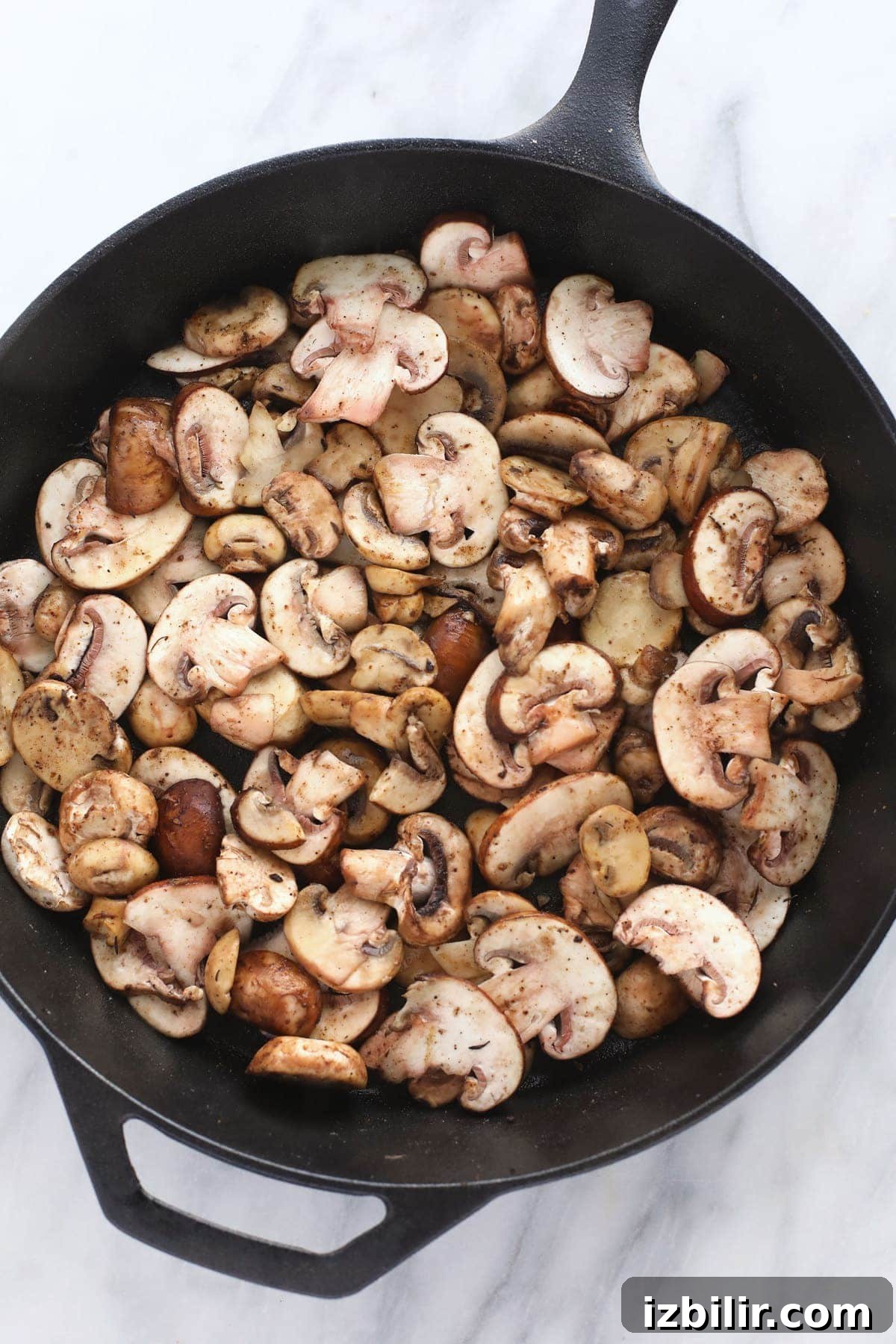 Creamy Chicken Marsala with Mushrooms 7 mushrooms ready to be sauteed in a cast iron skillet