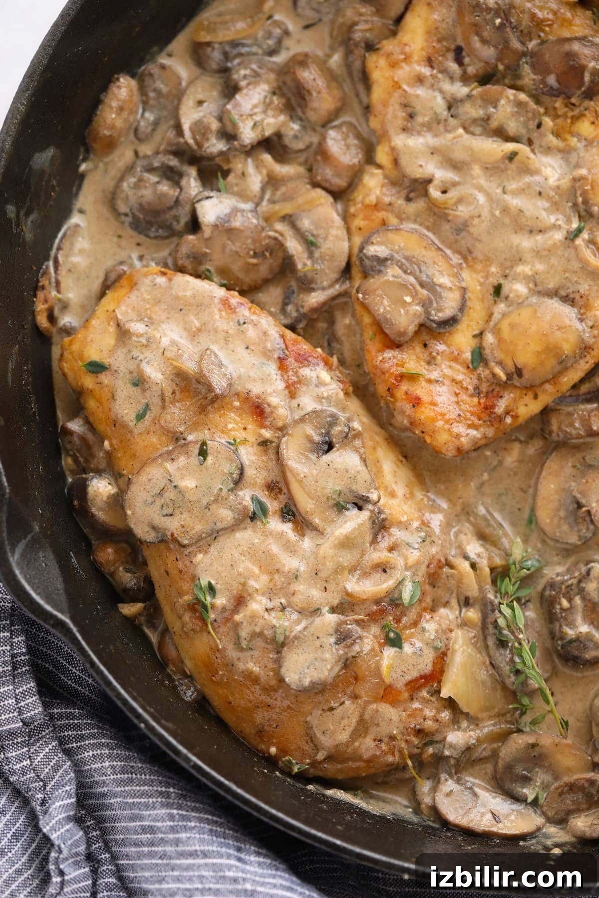 Creamy Chicken Marsala with Mushrooms 8 chicken marsala sauce poured over chicken breasts in a cast iron skillet