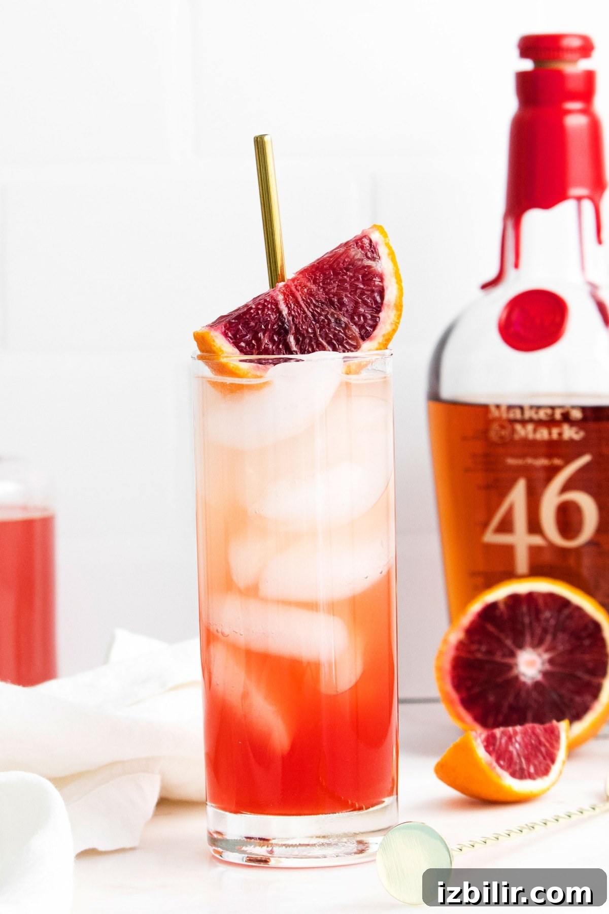 blood orange cocktail next to bourbon