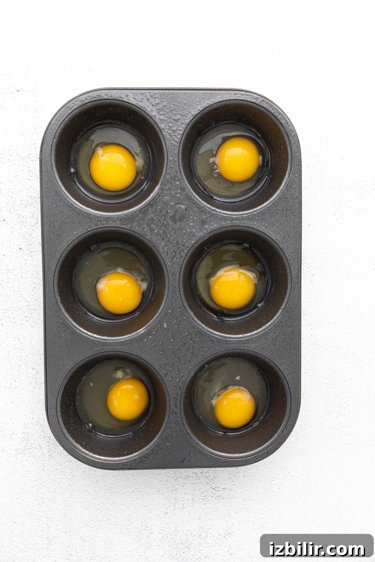 raw eggs in muffin tin